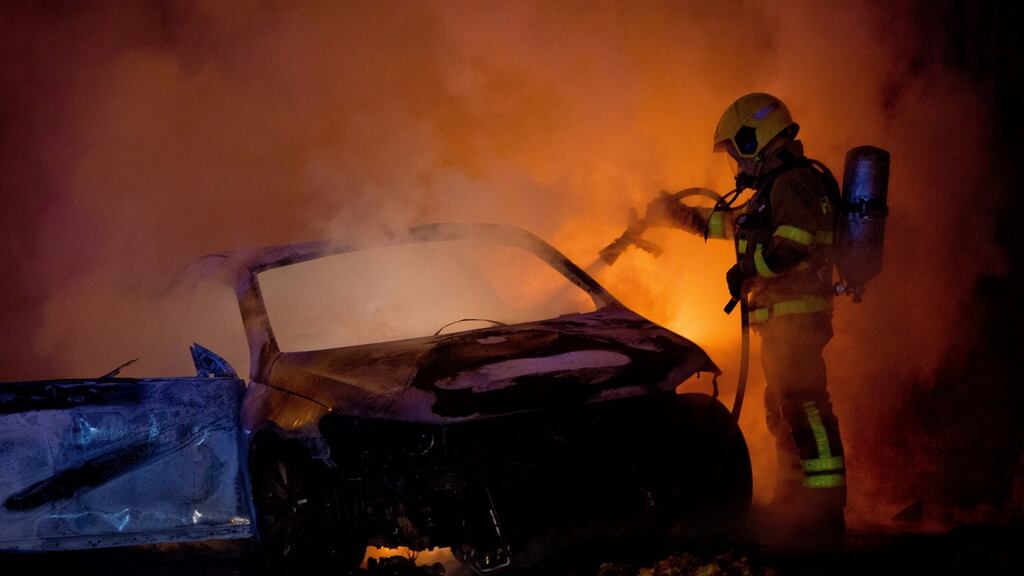 Dolphin’s Barn Fire Station D Watch: a firefighter puts out a car fire in Temple Manor Court. Photograph: Tom Honan