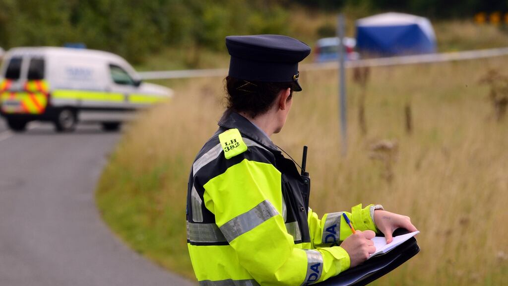 A garda at the scene in Kilcurry, Dundalk, where taxi driver Martin Mulligan was killed. Photograph: The Irish Times