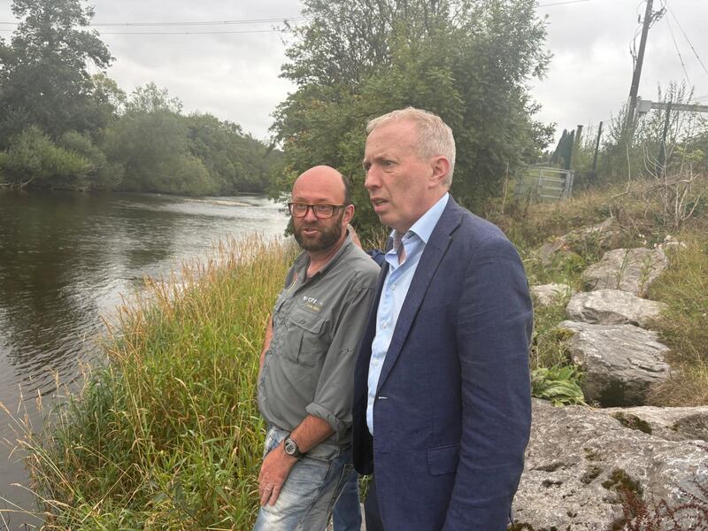 Mallow Trout Anglers chairman John Ruby showing Minister of State Timmy Dooley the impact of the fish kill on the river Blackwater. Photograph: Mallow Trout Anglers