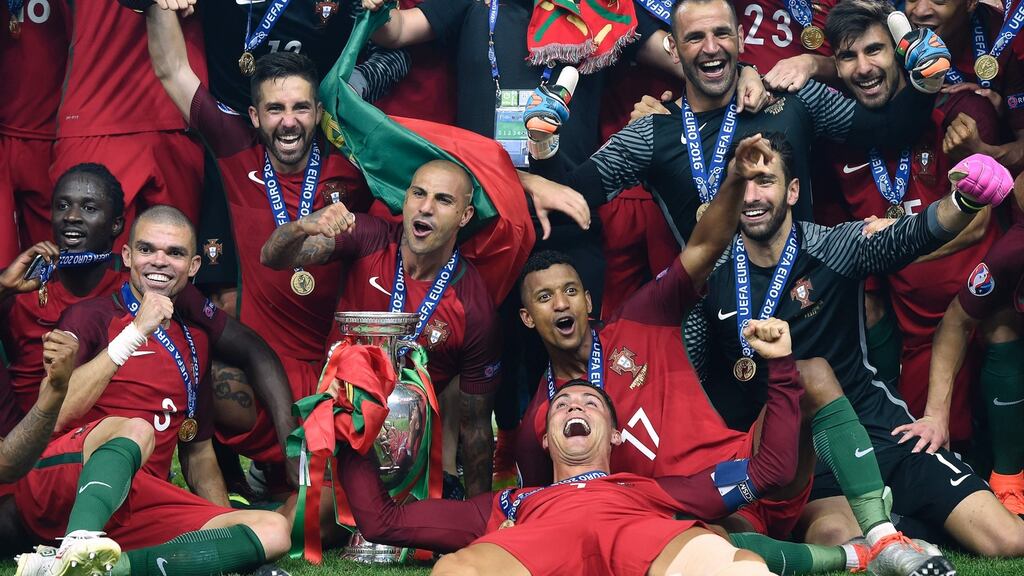 The Portugal team with the trophy as they celebrate beating France at the Stade de France. Photograph: Getty Images