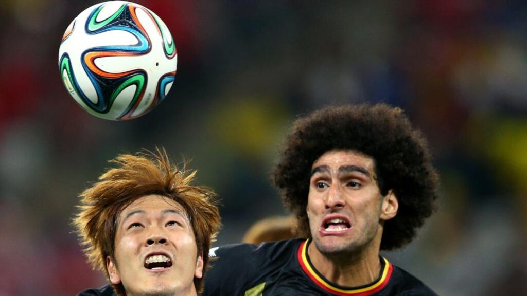 Marouane Fellaini, seen here in World Cup action for Belgium in Brazil, right, is reported toi have been meeting with officials of Napoli over a possible move to the Italian Serie A club. Photograph: Clive Mason /Getty Images