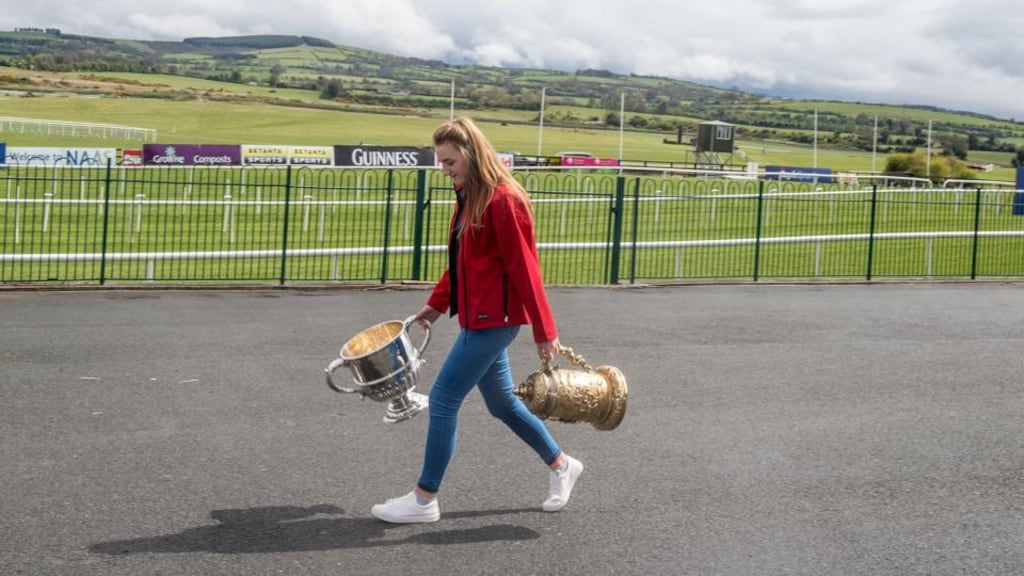 Sarah Kelly carries trophies into Punchestown for the annual racing festival. Photograph: Michael Chester