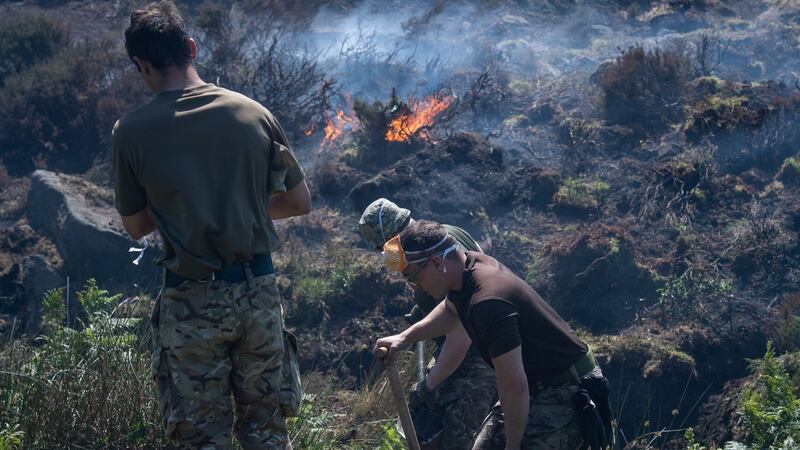 A British Ministry of Defence (MOD) handout photograph shows British Army soldiers of 4 Scots help dig ditches and ‘breaks’ to maintain the fires as they continue to support Great Manchester Fire and Rescue Service with the Saddleworth Moor fire, north west England, Britain, 29 June 2018. Photograph: Sgt Donald Todd via EPA.