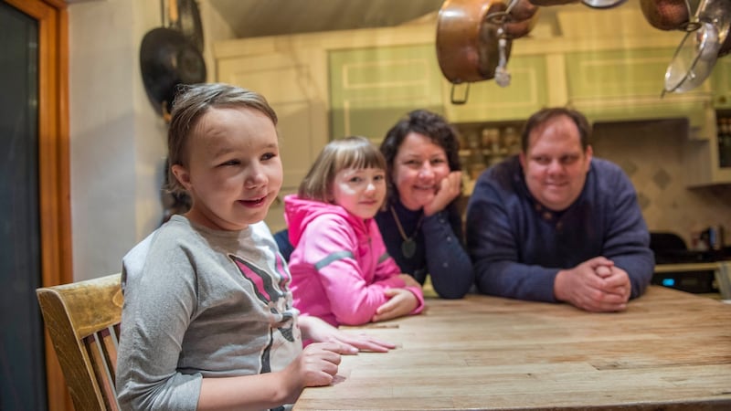 Coral Collier (9) with her sister Tanya (7) and parents Niki and Rem at their home in Dublin 8: “We are so isolated.” Photograph: Brenda Fitzsimons