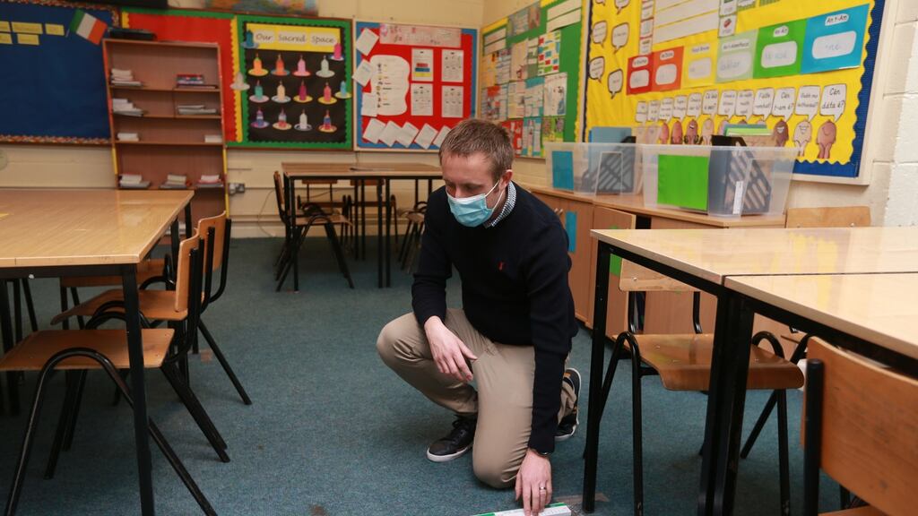 Conor O’Reilly, principal of Scoil Áine Naofa in Lucan, Dublin, measuring the distance between tables as he gets the school ready to reopen. Photograph: Laura Hutton
