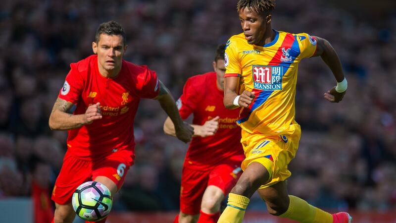 Liverpool’s Dejan Lovren chases Wilfried Zaha during Crystal Palace’s 2-1 win at Anfield on Sunday. Photograph: Peter Powell/EPA