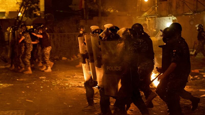 Riot police advance to push back anti-government protesters in Beirut on Thursday night. Photograph: Hassan Ammar/AP