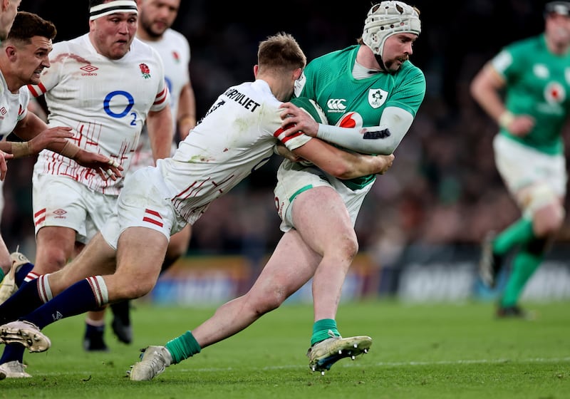 Ireland’s Mack Hansen is tackled by England's Jack van Poortvliet during the Grand Slam decider at the Aviva Stadium. Photograph: Billy Stickland/Inpho