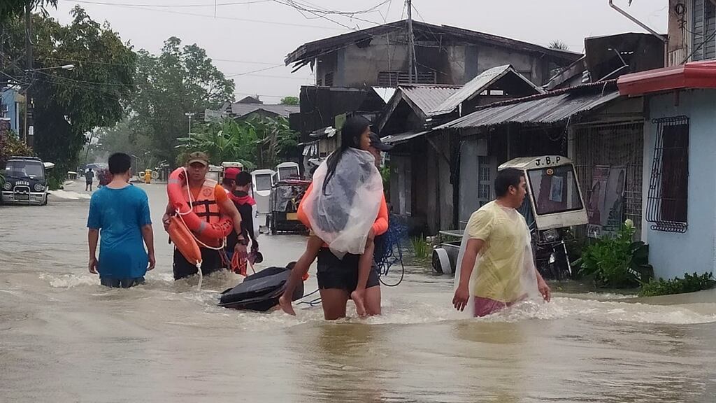 Heavy rains caused by a summer tropical depression have killed at least 25 people in the central and southern Philippines, mostly due to landslides. Photograph: EPA/PCG