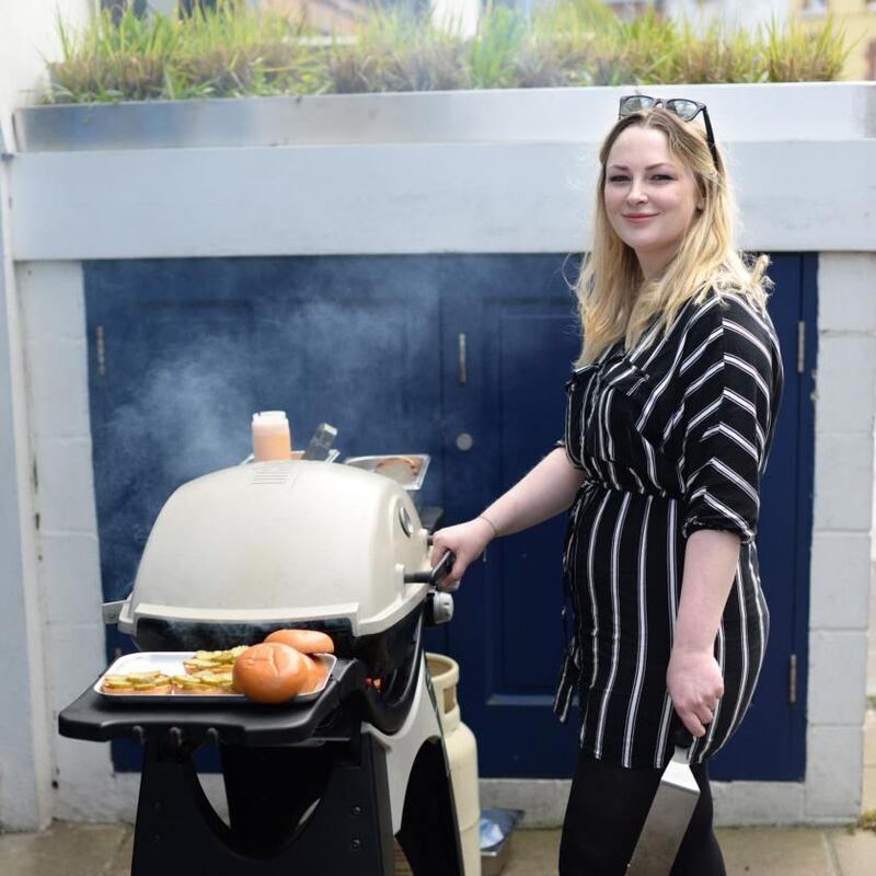 Grainne O’Keefe cooking her ultimate beef burgers on a barbecue outside BuJo, in Sandymount, Dublin. Photograph: Dara Mac Dónaill/The Irish Times