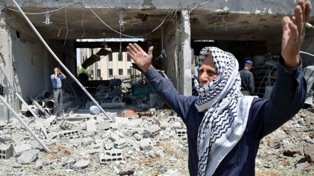 A man reacts yesterday at a site hit by what activists said was an air raid by forces loyal to Syria’s President Bashar al-Assad, in the Duma neighbourhood of Damascus. Photograph: Bassam Khabieh/Reuters