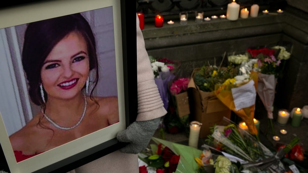 Flowers and candles are left at Leinster House during a vigil for Ashling Murphy. Photograph: Gareth Chaney/ Collins