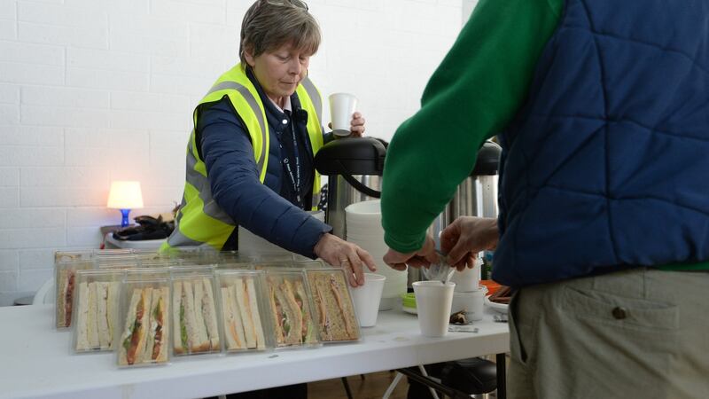 Staff prepare some food for service users at St Catherine’s sports hall in Marrowbone Lane, Dublin , where the Dublin Region Homeless Executive and Peter McVerry Trust have set up emergency beds. Photograph: Dara Mac Dónaill