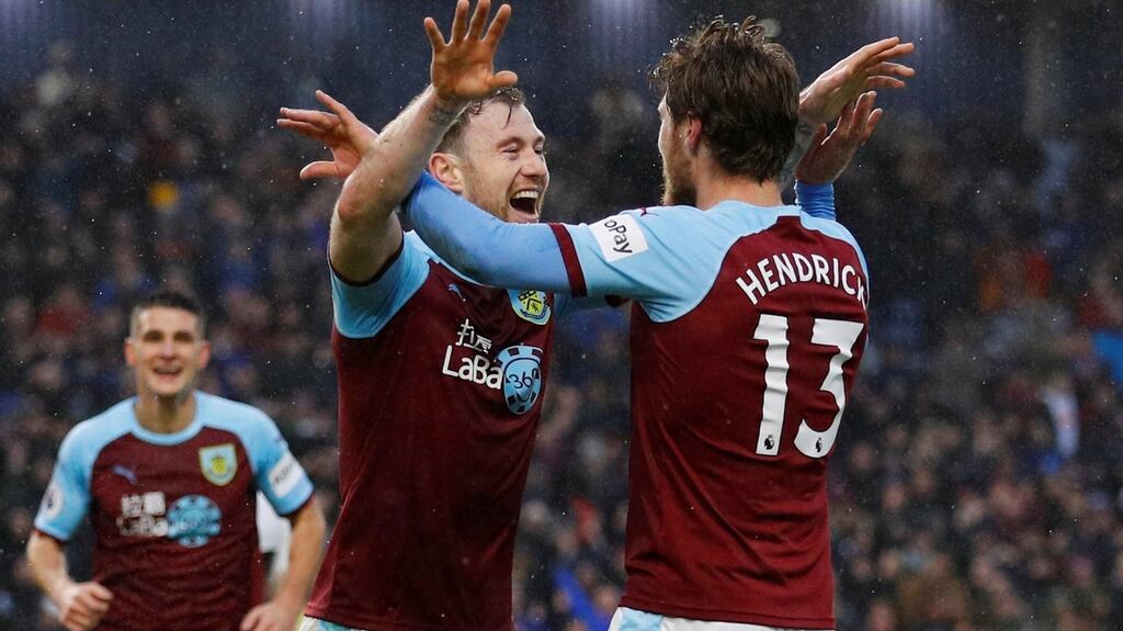 Burnley’s Ashley Barnes and Jeff Hendrick celebrate Fulham’s second own goal. Photograph: Reuters