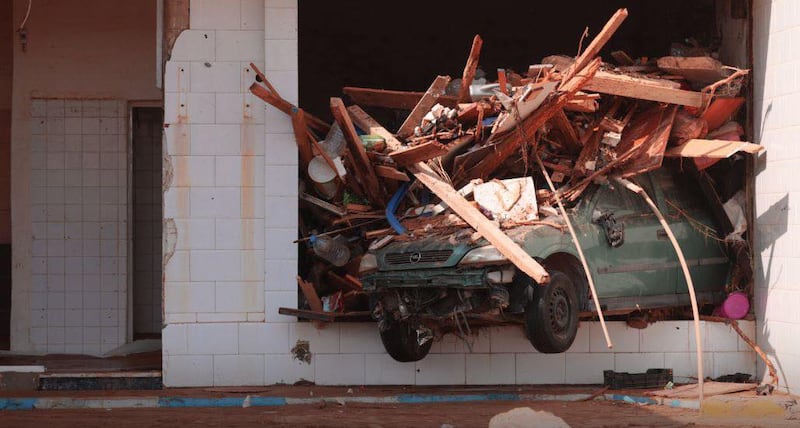 A car and debris are piled in a window of a building in Derna. Photograph: Handout/Anadolu Agency via Getty