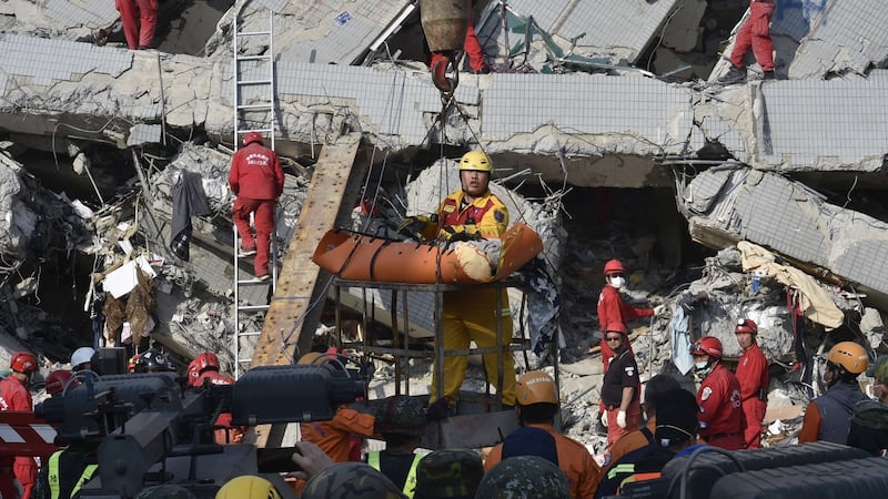 A rescue worker brings down a victim from the collapsed Wei Kuan complex building in Tainan, southern Taiwan, on on Sunday. Photograph: Sam Yeh/AFP/Getty Images