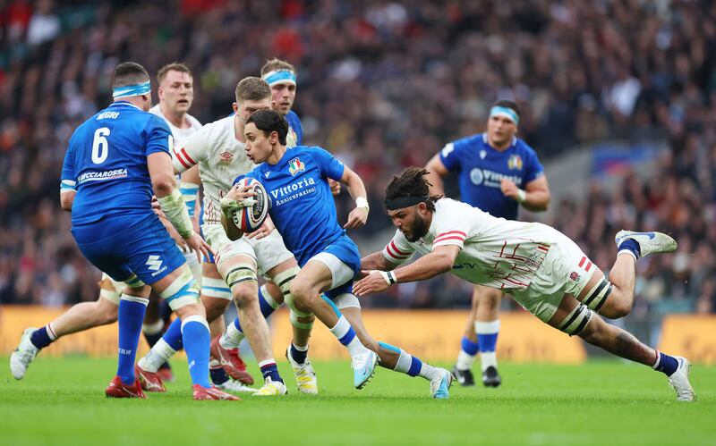 Ange Capuozzo of Italy is tackled by Lewis Ludlam. Photograph: Catherine Ivill/Getty