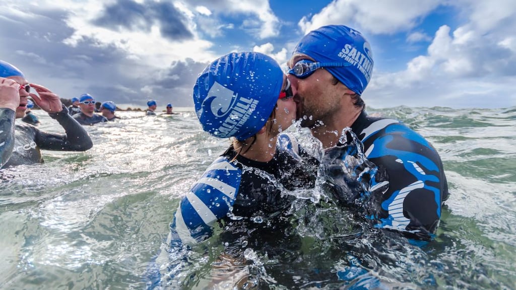 Summer Pix 2019: swimmers kiss before heading out to open water outside Salthill in Galway. Photograph: Martin Kalvaster
