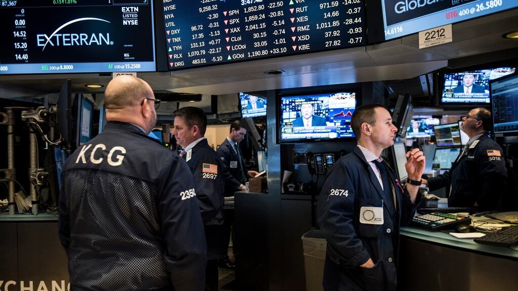 Traders on the floor of the New York Stock Exchange prior to market close: Wall Street was lower in morning trade, snapping a three-day rally, after a slump in Wal-Mart weighed on retail stocks and oil prices retreated. Photograph: Andrew Renneisen/Getty Images