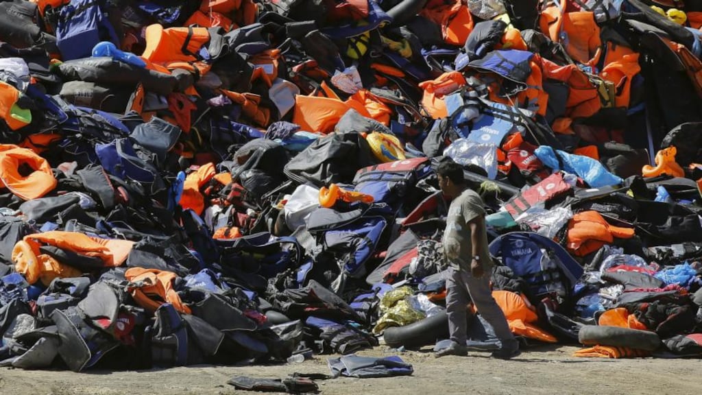 A girl believed to be five-years-old has died and as many as 13 people may be missing at sea off the Greek island of Lesbos. Photograph shows a local surveying a pile of deflated dinghies, tubes and life vests left by arriving refugees and migrants on tLesbos . Photograph: Yannis Behrakis /Reuters