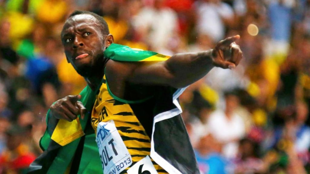 Usain Bolt of Jamaica poses with his national flag after winning the men’s 100 metres final during the IAAF World Athletics Championships at the Luzhniki stadium in Moscow. Photograph: Kai Pfaffenbach/Reuters