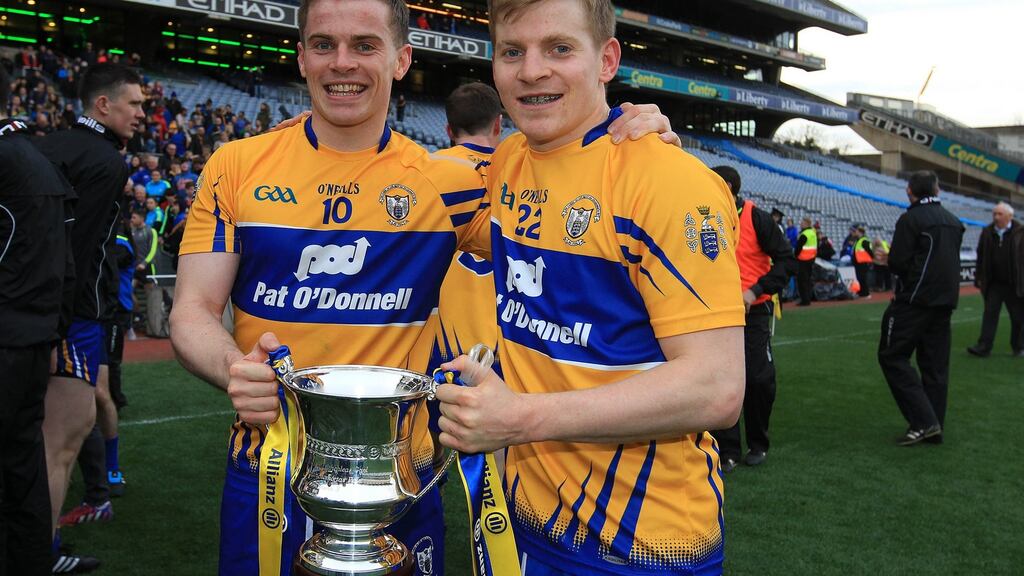 Clare’s Seán and Podge Collins celebrate winning Allianz Football League Division Three Final on Saturday. Podge will be targeting a Division One Hurling title with Clare next Sunday. Photograph: Lorraine O’Sullivan/Inpho