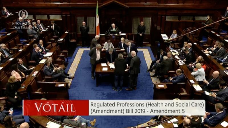 The officials clustering around a table on the floor of the chamber and scrutinising the result