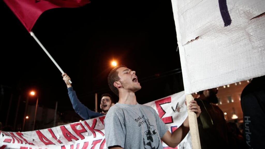 A supporter of Greece’s leftist main opposition Syriza party shouts slogans during an anti-government rally in front of the parliament in Athens last night. The government survived a Syriza filed a censure motion of no-confidence. Photograph: Yorgos Karahalis/Reuters.