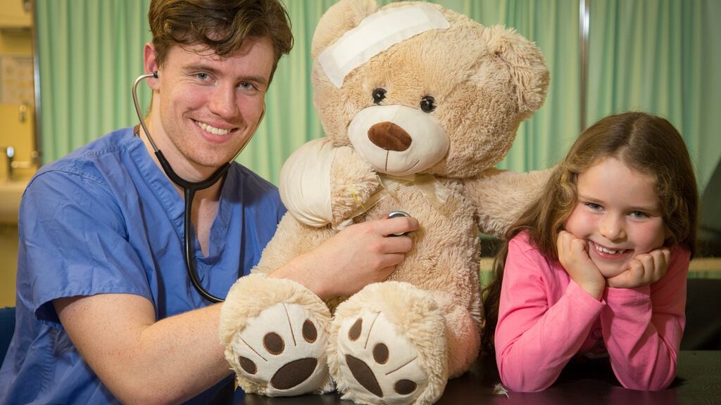 NUI Galway third year medical student Roberts Woods with six-year-old Aoibhin Farren. NUI Galway’s Sláinte Society are now accepting applications from primary schools for the 15th annual Teddy Bear Hospital event, which will take place on Thursday and Friday, January 16th and 17th. The event, aims to help children, aged 3-8, feel more comfortable around doctors and hospitals. To apply, see https://forms.gle/FNDBRrSmao1aeMnQA by Friday, November 15th. Photograph: Aengus McMahon.
