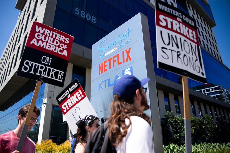 Members of the Writers Guild of America and supporters picket outside of Netflix's offices in Los Angeles, July 13, 2023. Leaders of the Hollywood union SAG-AFTRA, representing 160,000 television and movie actors, voted to strike on Thursday. Screenwriters have already been picketing for over 70 days. (Jenna Schoenefeld/The New York Times)