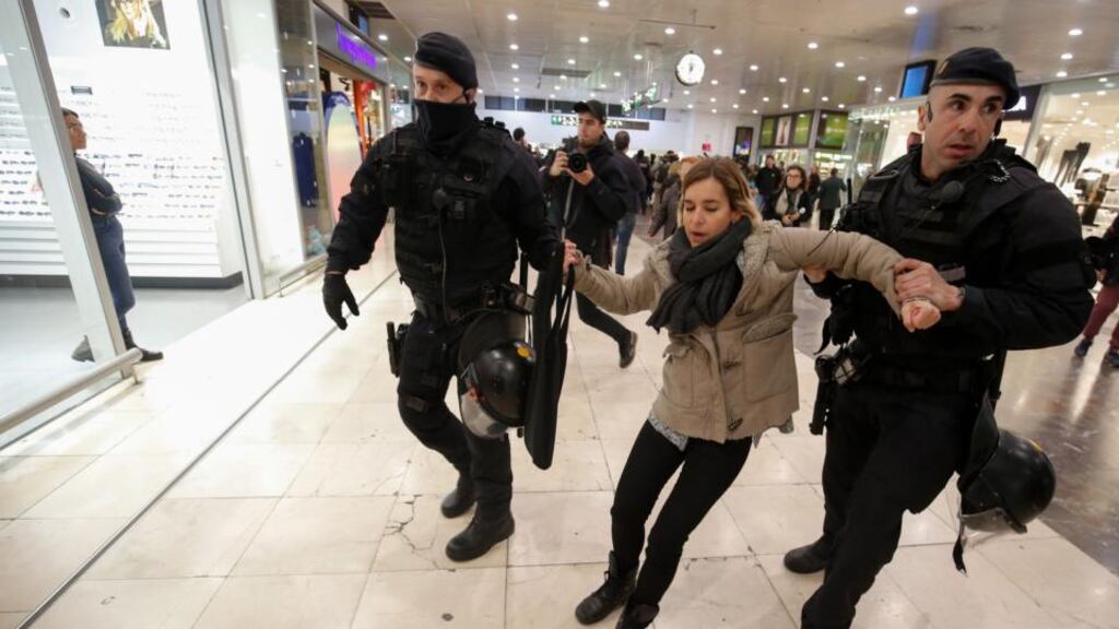 Catalan regional police (Mossos D’Esquadra) officers evacuate a demonstrator as others sit and block the access to the platforms, at Barcelona Sants railway station during a protest called by local Republic Defence Committees (CDR) on Saturday in Barcelona. Photograph: Pau Barrena/AFP/Getty