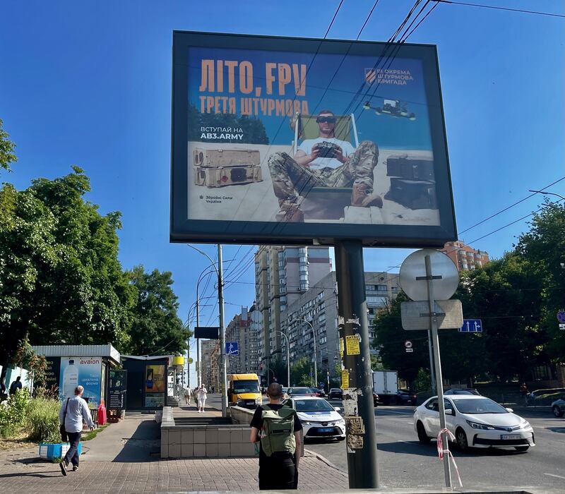 A Kyiv billboard promoting recruitment by the country's Third Separate Assault Brigade, showing a soldier flying a first-person view (FPV) drone. It reads: 'Summer. FPV. The Third Assault.' Photograph: Daniel McLaughlin