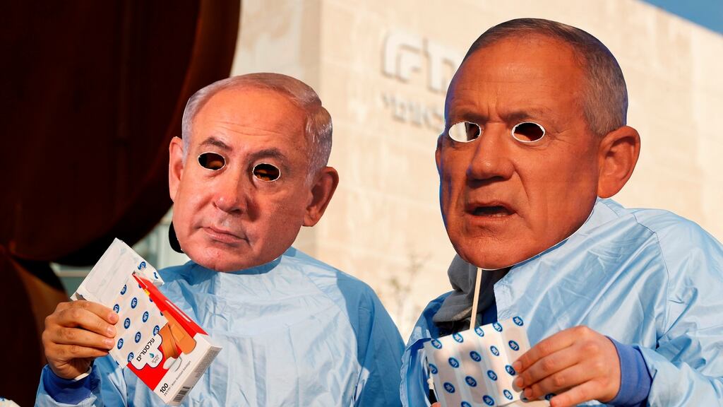 Israelis from the Centres For Social Justice wearing masks of prime minister Benjamin Netanyahu (left) and alternate prime minister Benny Gantz, protest for the passage of the social budget and the dissolution of the Israeli parliament on December 2nd in Tel Aviv. Photograph: Jack Guez/AFP via Getty