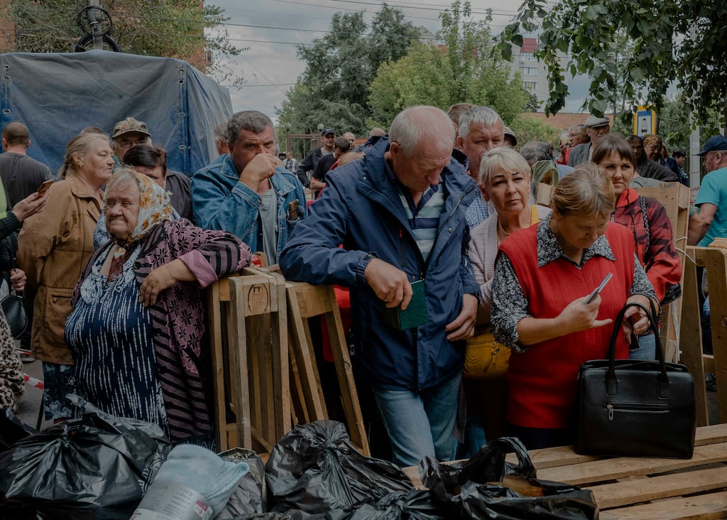 Russians who fled recent Ukrainian military incursions into a border region wait for distribution of aid in Kursk, Russia. Photograph: Nanna Heitmann/The New York Times