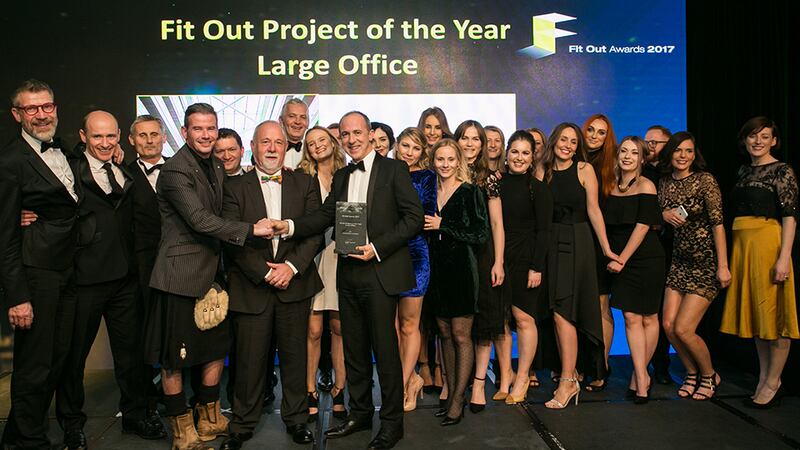 Chris Pae, Senior Accounts Manager, Optima Products, presents the Fit Out Project of the Year – Large Office award to the Henry J. Lyons team