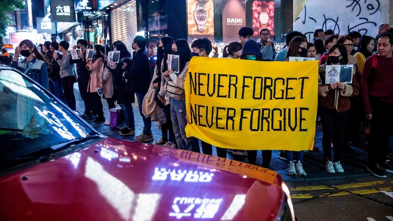 Protesters take part in a human chain rally at the Tsim Sha Tsui district of Hong Kong on Tuesday. Pro-democracy protesters in Hong Kong held hands and formed human chains across the city. Photograph: Isaac Lawrence/AFP/Getty
