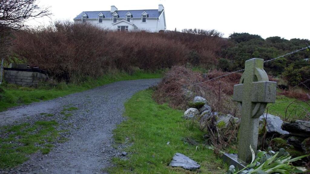 The house in Schull, Co Cork, that belonged to Sophie Toscan du Plantier and the cross that marks the spot where she was found murdered. Photograph: Eric Luke