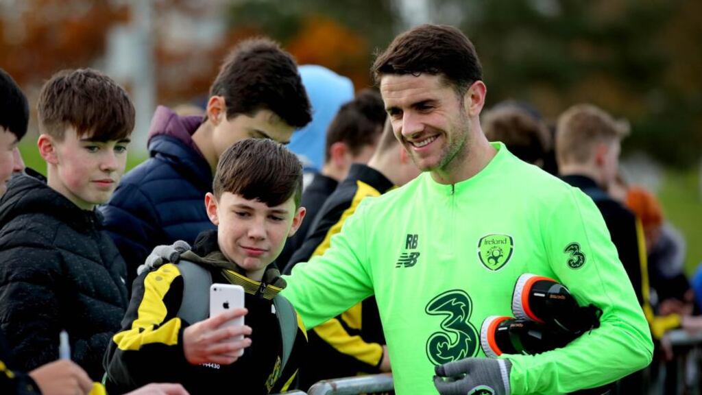 Ireland’s Robbie Brady poses for a picture with a young fan during training ahead of the friendly with Northern Ireland. Photo: Ryan Byrne/Inpho