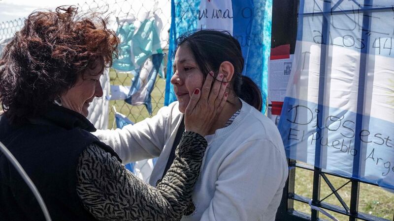 Elena Alfaro (right), sister of missing submarine crew memeber Cristian David Ibanez, being comforted outside Argentina’s navy base in Mar del Plata, south of Buenos Aires. Photograph: Eitan Abramovich/AFP/Getty Images