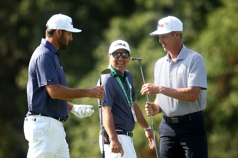 Scottie Scheffler talks with caddie Ted Scott and vice captain Kevin Kisner. Photograph: Jared C Tilton/Getty