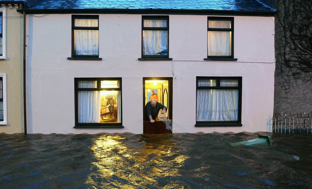 Against the odds: Michael Dennehy attempts to keep the water out of his Ballylongford, Co Kerry, home. Atlantic storm Ruth will move across Ireland today bringing gusts of up to 110km/h. Photograph: Domnick Walsh/Eye Focus