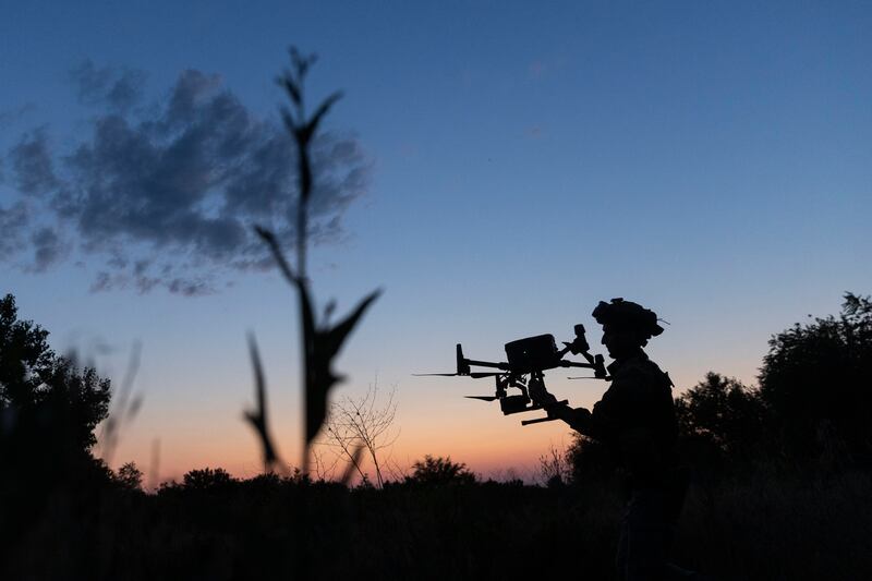 A Ukrainian soldier catches a drone used to correct Ukrainian artillery fire on Russian positions in the Zaporizhzhia region of southern Ukraine. Photograph: David Guttenfelder/The New York Times