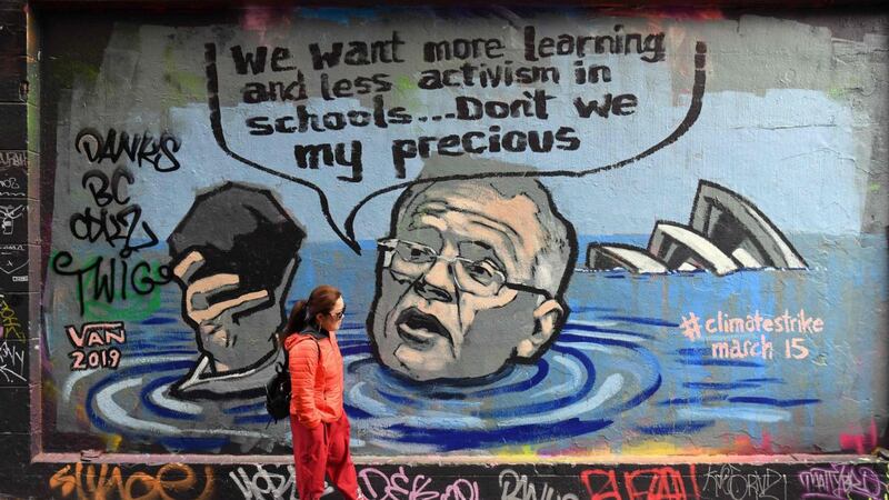 A mural shows Australian prime minister Scott Morrison holding a lump of coal as it advertises a rally by students across the world to protest against climate change, in Melbourne. Photograph: William West/AFP/Getty Images