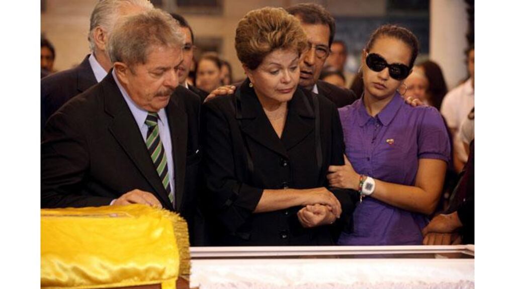 Brazil's former President Luiz Inacio Lula da Silva (left), Brazil's President Dilma Rousseff and Rosa Virginia, daughter of Venezuela's late president Hugo Chavez, view his coffin during a wake in Caracas yesterday. Photograph: Reuters