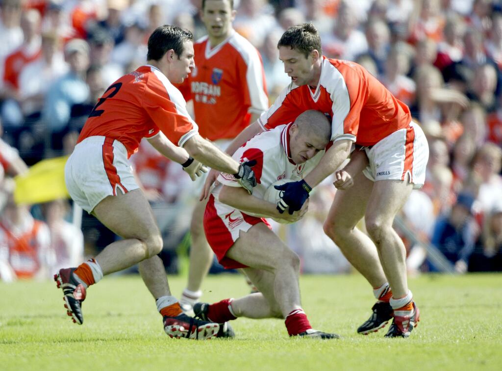 Tyrone's Stephen O'Neill is tackled by Enda McNulty and Kieran McGeeney of Armagh in an Ulster championship replay on May 26th, 2002. Photograph: Patrick Bolger/Inpho