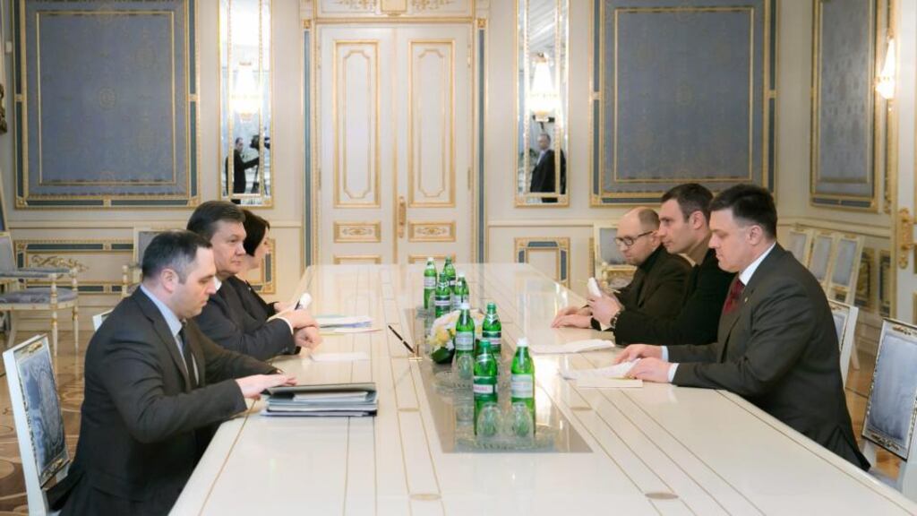 Ukrainian president Viktor Yanukovich (centre left) speaks with opposition leaders (from back right) Arseniy Yatsenyuk, Vitali Klitschko and Oleh Tyagnybok yesterday. Photograph: EPA