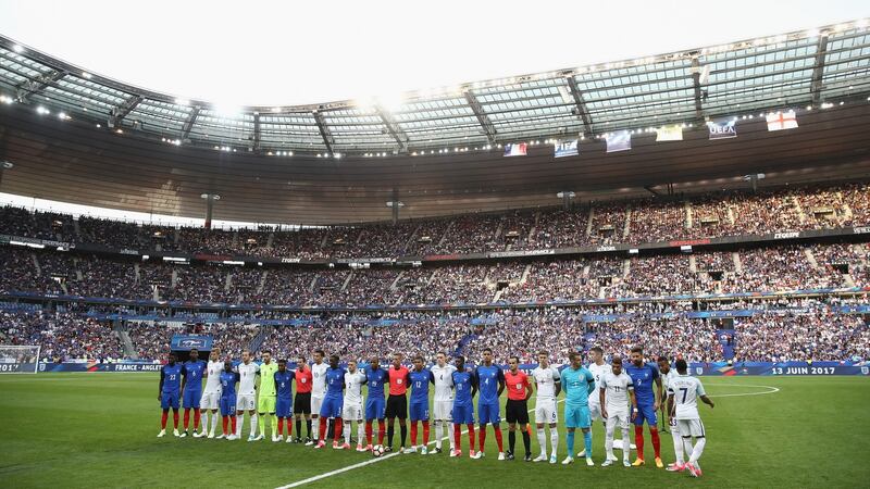 Players and officials line up together prior to kick-off at Stade de France. Photograph: Julian Finney/Getty Images