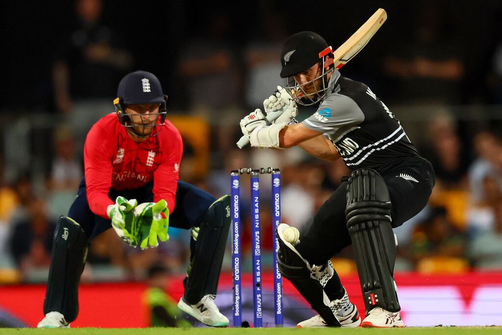 New Zealand's Captain Kane Williamson plays a shot watched by England's wicketkeeper Jos Buttler during the ICC men's Twenty20 World Cup match. Photograph: Patrick Hamilton/AFP via Getty Images