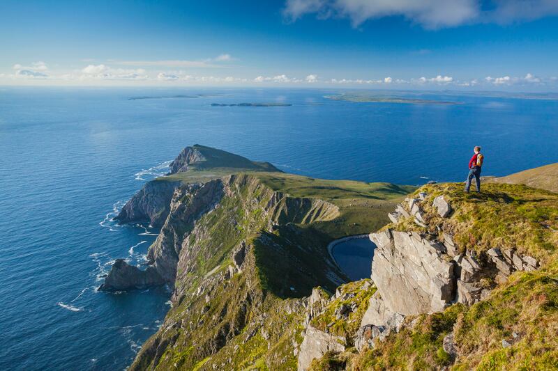 Walker looking towards Saddle Head from Croaghaun, Achill Island, Co Mayo