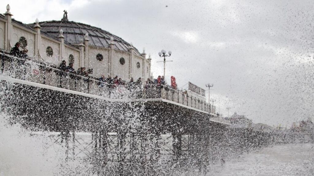 Waves crash near Brighton Pier in East Sussex. Photograph: Gareth Fuller/PA